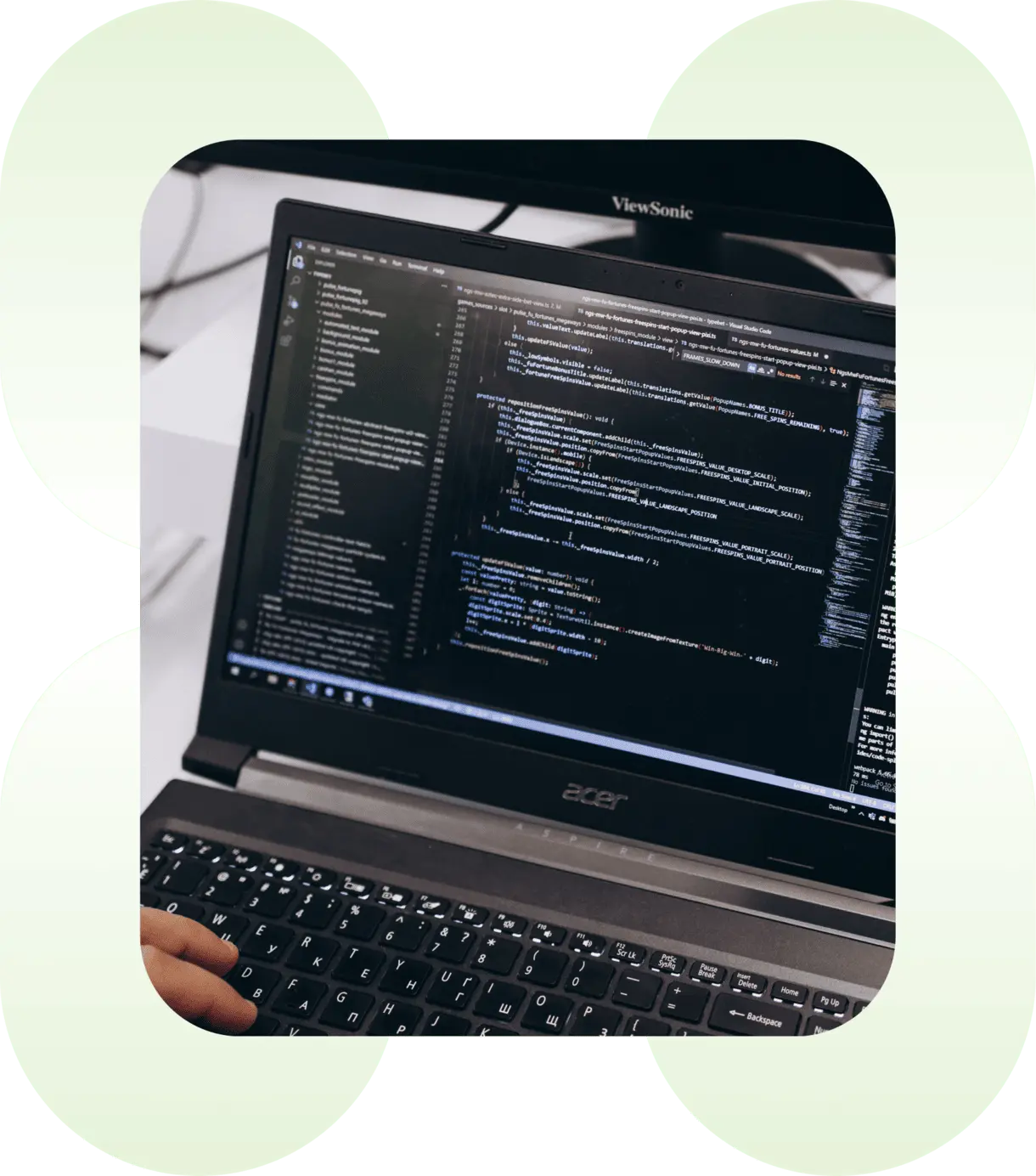 composition of a laptop with code and green shapes